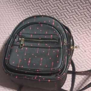 Under One Sky Black Backpack with Red Arrow Design